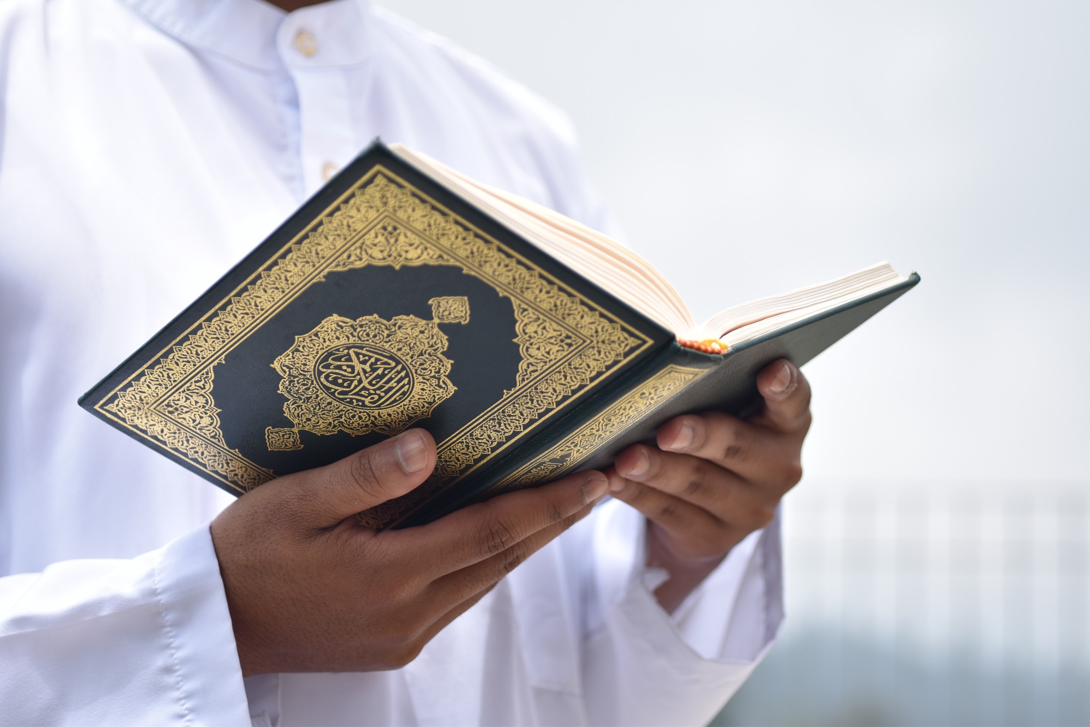 holy-quran-in-hand-with-arabic-calligraphy-meaning-2025-02-09-22-18-31-utc